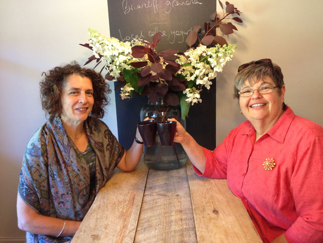 Donna Dallal Ferne and Deb Vandenbroucke toast each other's success and happiness